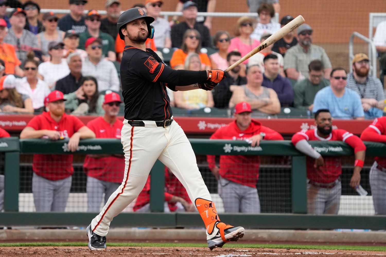 Feb 26, 2024; Scottsdale, Arizona, USA; San Francisco Giants third baseman JD Davis (7) hits against the Los Angeles Angels in the first inning at Scottsdale Stadium.